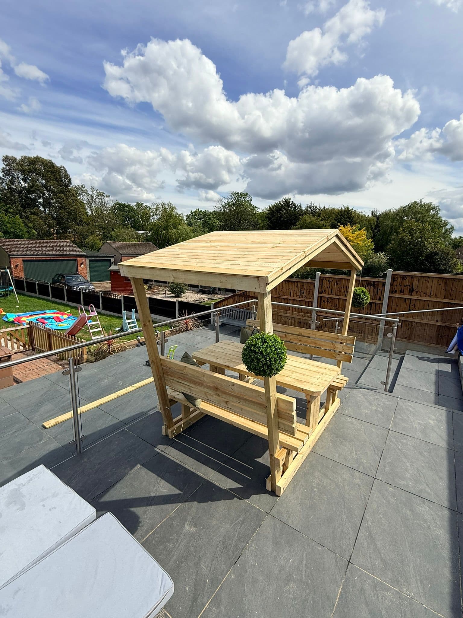 Bespoke timber pergola seating and table built by TimBear Builds