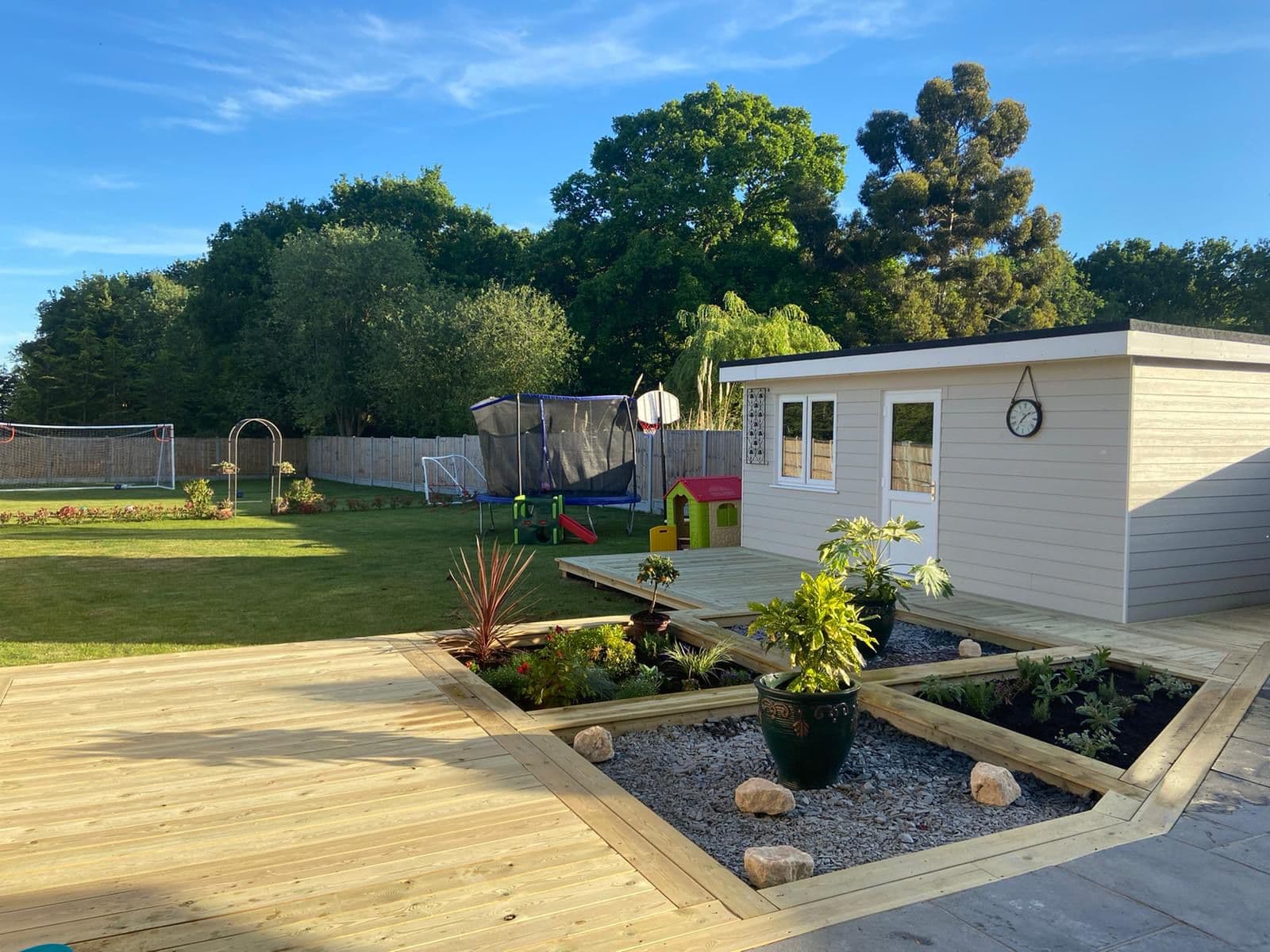 Finished timber decking, planters and garden room project in Essex